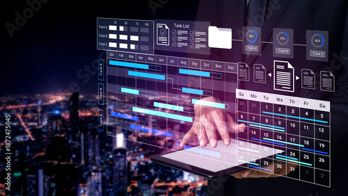 Tableau sur toile A businessman reviews crucial data on a tablet, with a captivating city backdrop at night