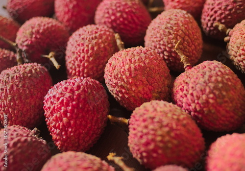 Ripe lychee fruits on a surface. Close-up. Scientific name Litchi chinensis Sonn, also known as lychee and alexia.