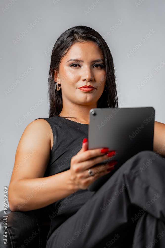 Fototapeta premium Portrait of serious business woman holding digital tablet