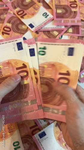 Counting euro banknotes. Female hands count 10 euros cash. Investments, family budget and savings concept	