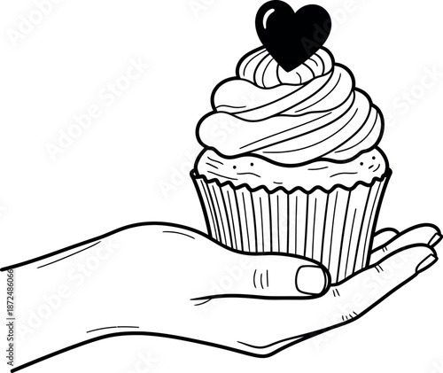 Human hand delicately holding a charming sweet decorated cupcake adorned with a lovely heart symbol