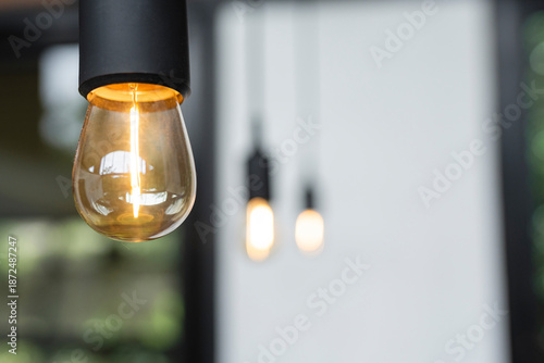 Bild auf Leinwand Vintage filament light bulb close up with bokeh background
