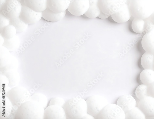 Close-up view of fluffy, white bubbles bordering a clean, white, rectangular void
