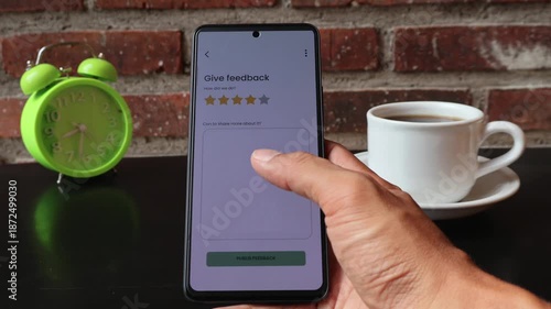 Closeup of hand doing online rating on mobile phone