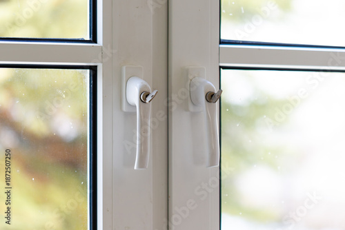 White window handles providing home security and protection