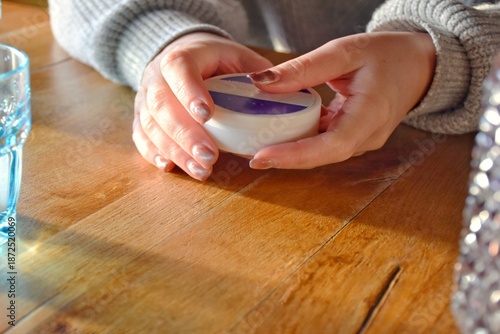 фотографія A box of snus pads in the girl's hands replaces smokeless cigarettes