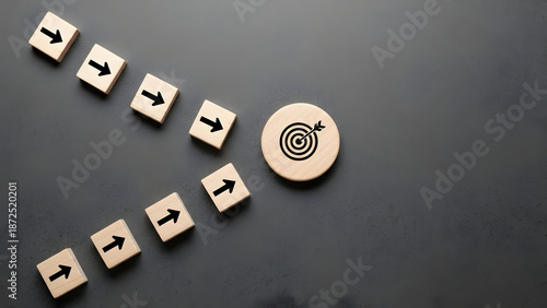 Achieving your business goals requires a clear vision and strategy, as demonstrated by these wooden blocks pointing towards a target, indicating success.