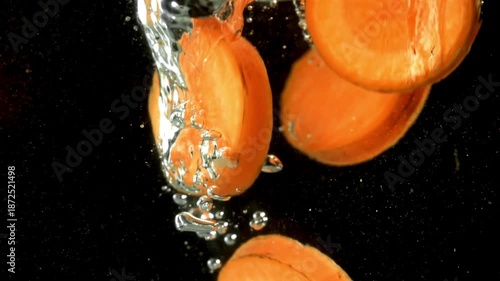 Super slow motion carrot slices. Filmed on a high-speed camera at 1000 fps. High quality FullHD footage