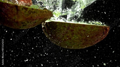 Super slow motion fresh avocado with splashes and drops. Filmed on a high-speed camera at 1000 fps. High quality FullHD footage