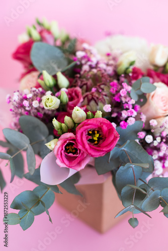 Close-up of a beautiful bouquet of flowers against a pink background