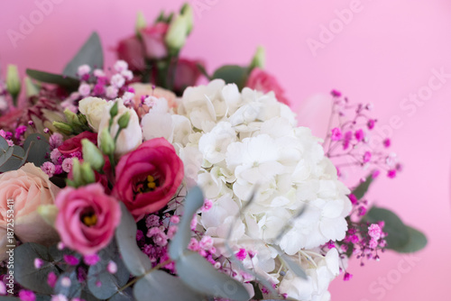 Close-up of a beautiful bouquet of flowers against a pink background