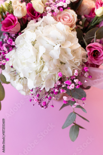 Close-up of a beautiful bouquet of flowers against a pink background