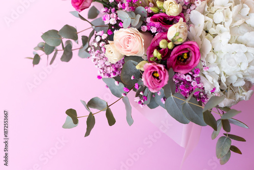 Close-up of a beautiful bouquet of flowers against a pink background