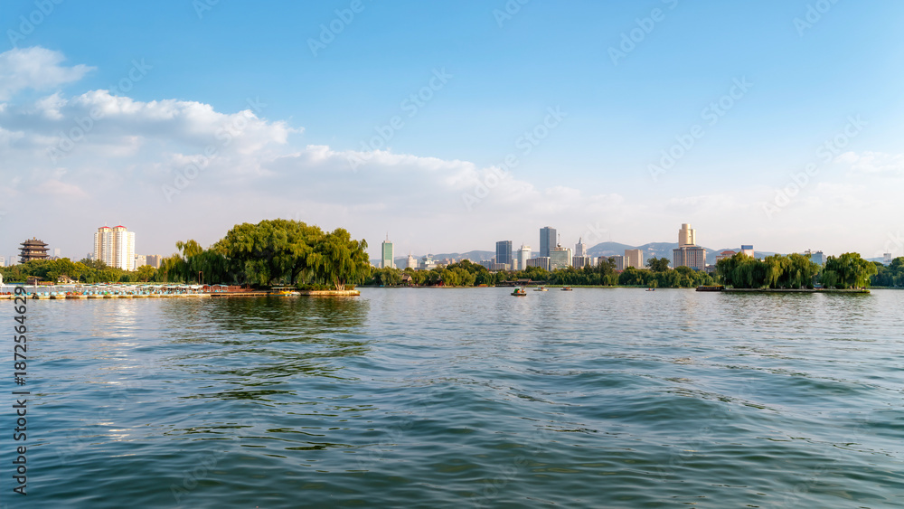 Fototapeta premium Scenic View of Lake with City Skyline