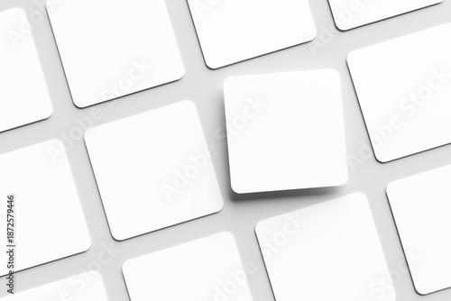 Blank white square business card mockup, placed on a gray background. Flat lay, top view, open composition.