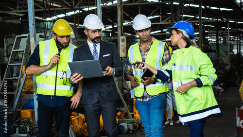 Industrial Engineers and Manager Discussing Production Plan in Factory