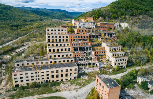 Aerial view of an abandoned mining and processing plant in a mountainous region