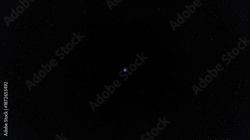 A small blue dot in a dark space against a white background.
