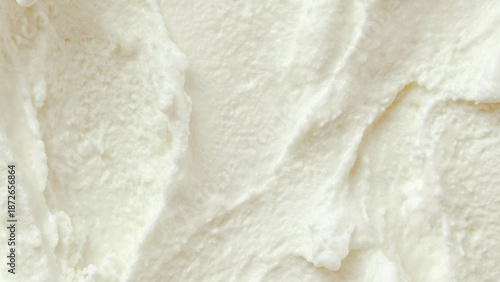 Creamy white ice cream texture with smooth swirls and soft ridges, rich and cold appearance, close-up macro view, dessert and frozen treat background.