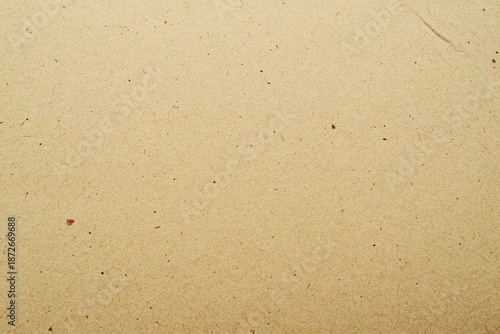 Close-up of textured brown paper with subtle speckles representing a natural and organic background.