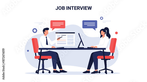 Professional job interview between hiring manager and candidate with laptop and resumes on desk in a corporate office setting.