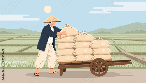 A farmer wearing a conical hat loads sacks of grain onto a cart in a rice paddy field.