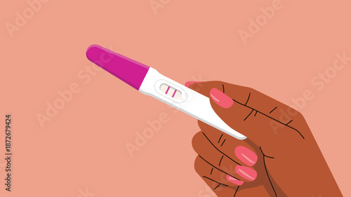 A person with dark skin holds a positive pregnancy test showing two lines
