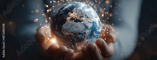 Hand holding globe with glowing effects symbolizing connectivity  