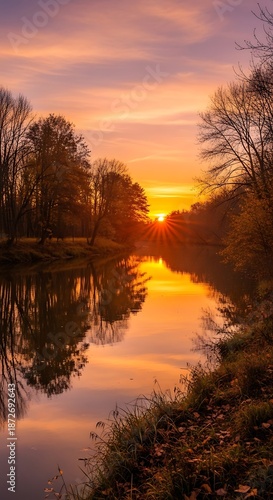 Tranquil sunset over a calm river reflecting trees and colorful sky scenery