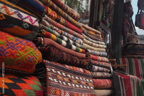 Wallpaper Mural Colorful woven rugs stacked in a market shop Torontodigital.ca