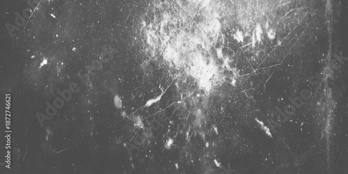 A dramatic black and white texture displays scratches and light flares across a dark grainy surface