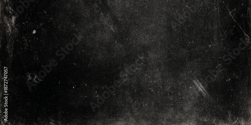 A dark grainy and textured background with subtle dust and scratch marks suggesting age or damage