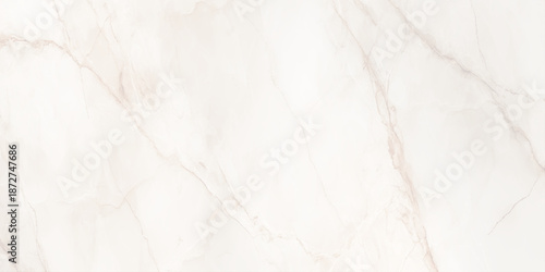 A close up view of a luxurious white marble texture with subtle golden veins and a smooth polished surface