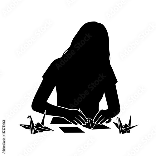 Silhouette of a woman folding origami paper cranes. Minimalist black vector illustration of paper craft hobby. Isolated on white background