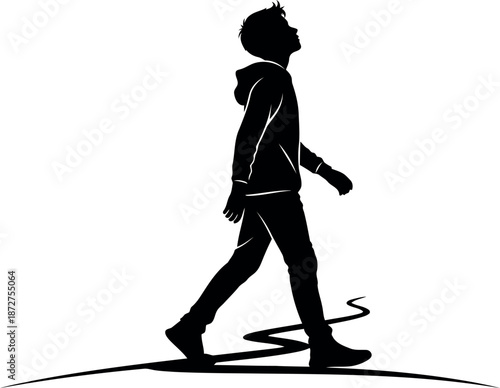 Silhouette of a person walking alone in a monochromatic scene
