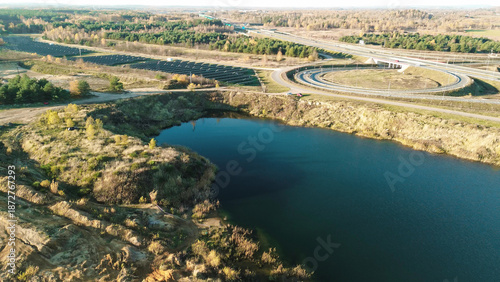 Tablou pe pânză Flooded quarry and forested landscape aerial view