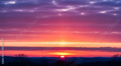 Vibrant sunset over horizon with colorful sky and clouds during daytime
