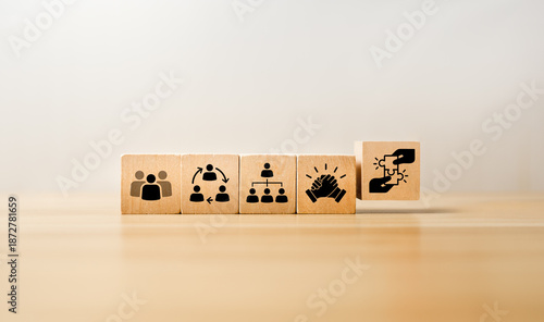 Wooden blocks displaying icons of teamwork, collaboration, organizational structure, leadership, partnership, representing corporate culture, team management, strategic cooperation, effective business