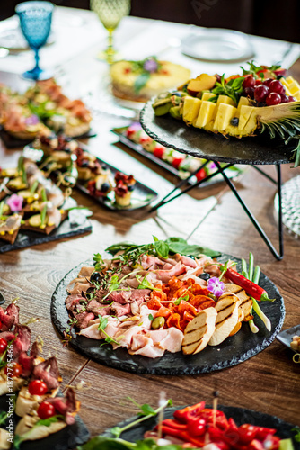 Fotografi A colorful array of appetizers and fruits invites guests to savor the delightful