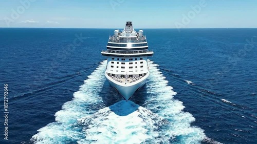 A luxury passenger vessel travels across the blue summer ocean from the open sea toward a white cruise ship docked at the busy vacation port harbor