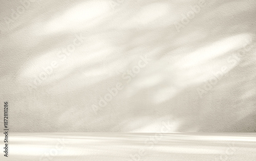 Beige room background with sunlight superimposed shadow leaves on the wall. autumn background template for product presentation concept