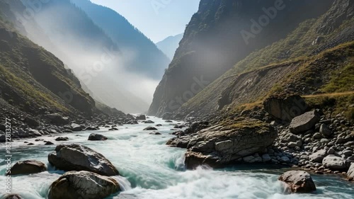 Majestic river flowing through rocky valley in morning fog  , Raging river flowing from a misty mountain canyon