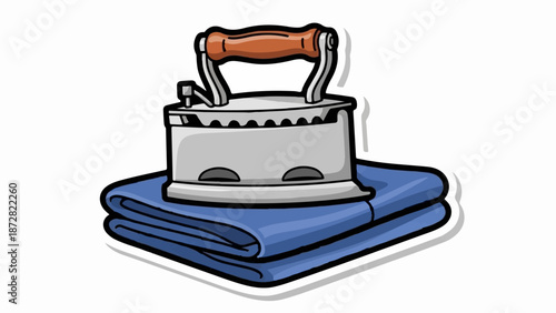 An old-fashioned iron rests on a stack of neatly folded blue fabric