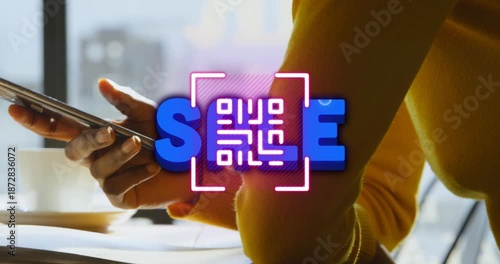 bra woman is texting her friend while enjoying a cup of coffee