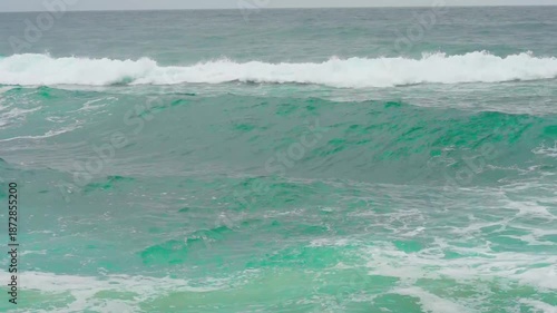 Waves of the East Sea crash against the breakwater and rocky shore, South Korea