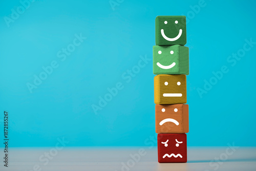 Fotografia Customer evaluation concept with wooden blocks showing different facial expressions representing satisfaction feedback ,service quality of user experience rating and business performance