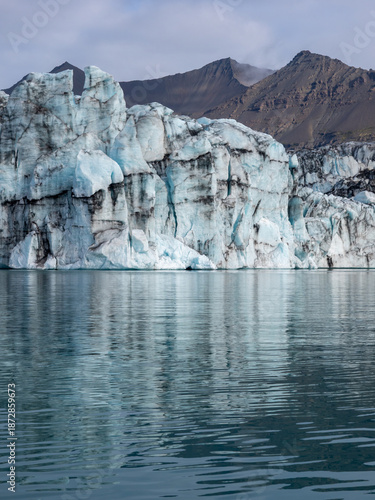 Glacier descending into water in Iceland's Jokulsarlon Glacier Lagoon