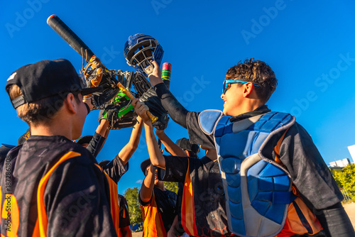 Photography Youth baseball team celebrating victory with equipment raised high