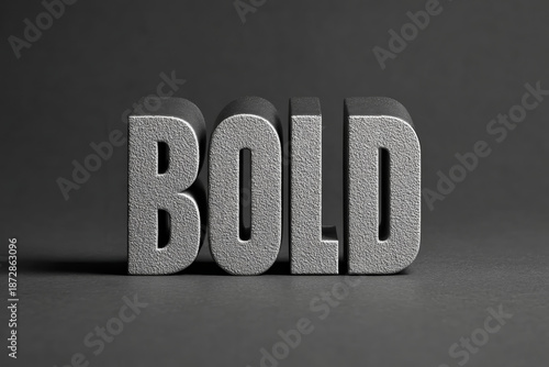 BOLD Typography: A striking typographic composition with the word BOLD rendered in a robust, three-dimensional style, highlighting its impactful and assertive nature against a subtle gray backdrop.