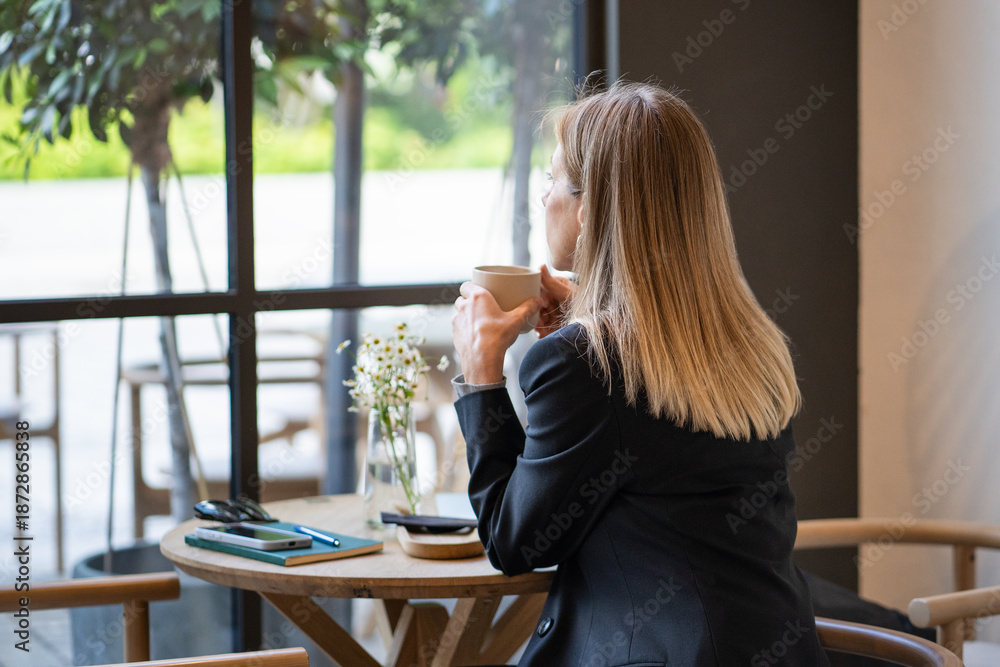 © DimaBerlin - Pensive businesswoman takes coffee break in cafe, looks out window. Sad woman experiencing emotional burnout from multitasking at work, sitting in cafeteria alone, thinking about life troubles. © DimaBerlin - Pensive businesswoman takes coffee break in cafe, looks out window. Sad woman experiencing emotional burnout from multitasking at work, sitting in cafeteria alone, thinking about life troubles.